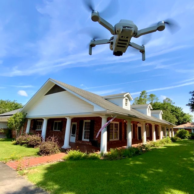 Launching the drone for aerial roof coverage on a brick home