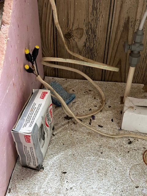 Loose wiring and debris at an open interior wall cavity